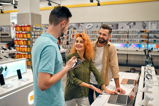 Customer selling assorted electronics during a quick in-store evaluation at PayMore Doraville